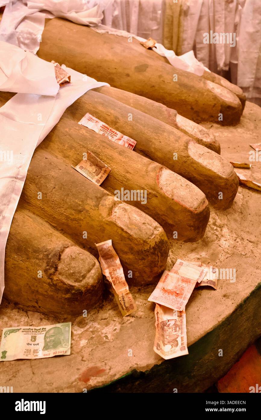 Devotional offerings placed at the feet of the giant clay Maitreya statue in Basgo’s 16th-century temple, Ladakh, India. Stock Photo