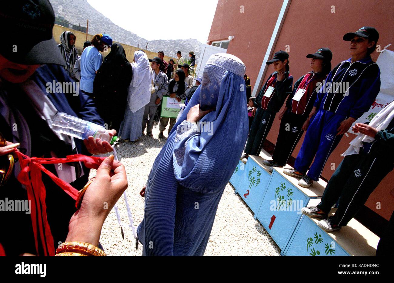 Aug 24, 2005; Kabul, AFGHANISTAN; A woman wearing the traditional burka, participates in the female ceremony awards at Bagh-e-Zanana. More than 300 athletes, including 80 female athletes, experienced a taste of happiness and achievement for the first time in their lives. They competed in athletics, bocce and football (soccer). Because of cultural restrictions, males and females competed at separate venues..  (Credit Image: Kash Gabriele Torsello/ZUMAPRESS.com) Stock Photo