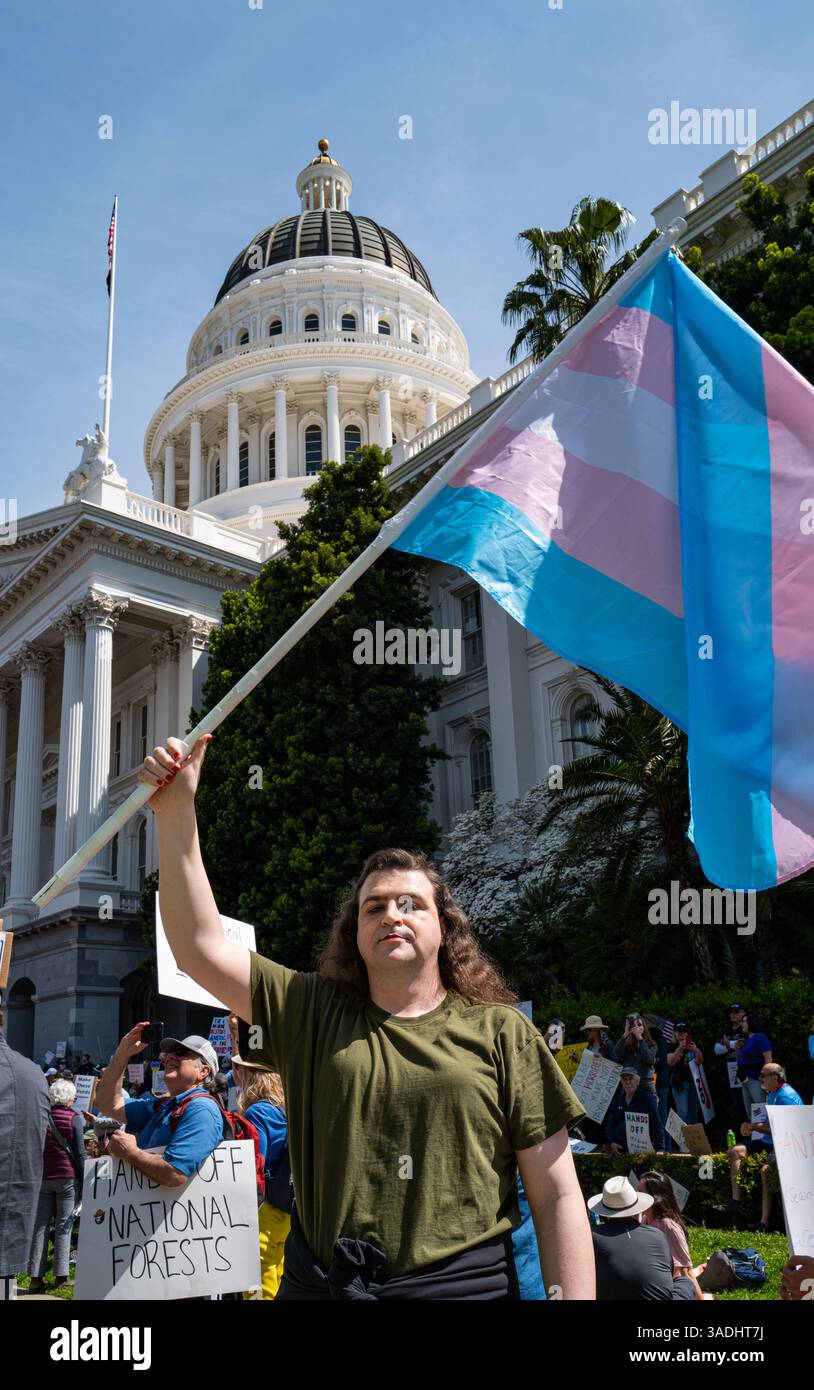 Local resident Cece R. holds up a trans flag in front of the Capitol ...
