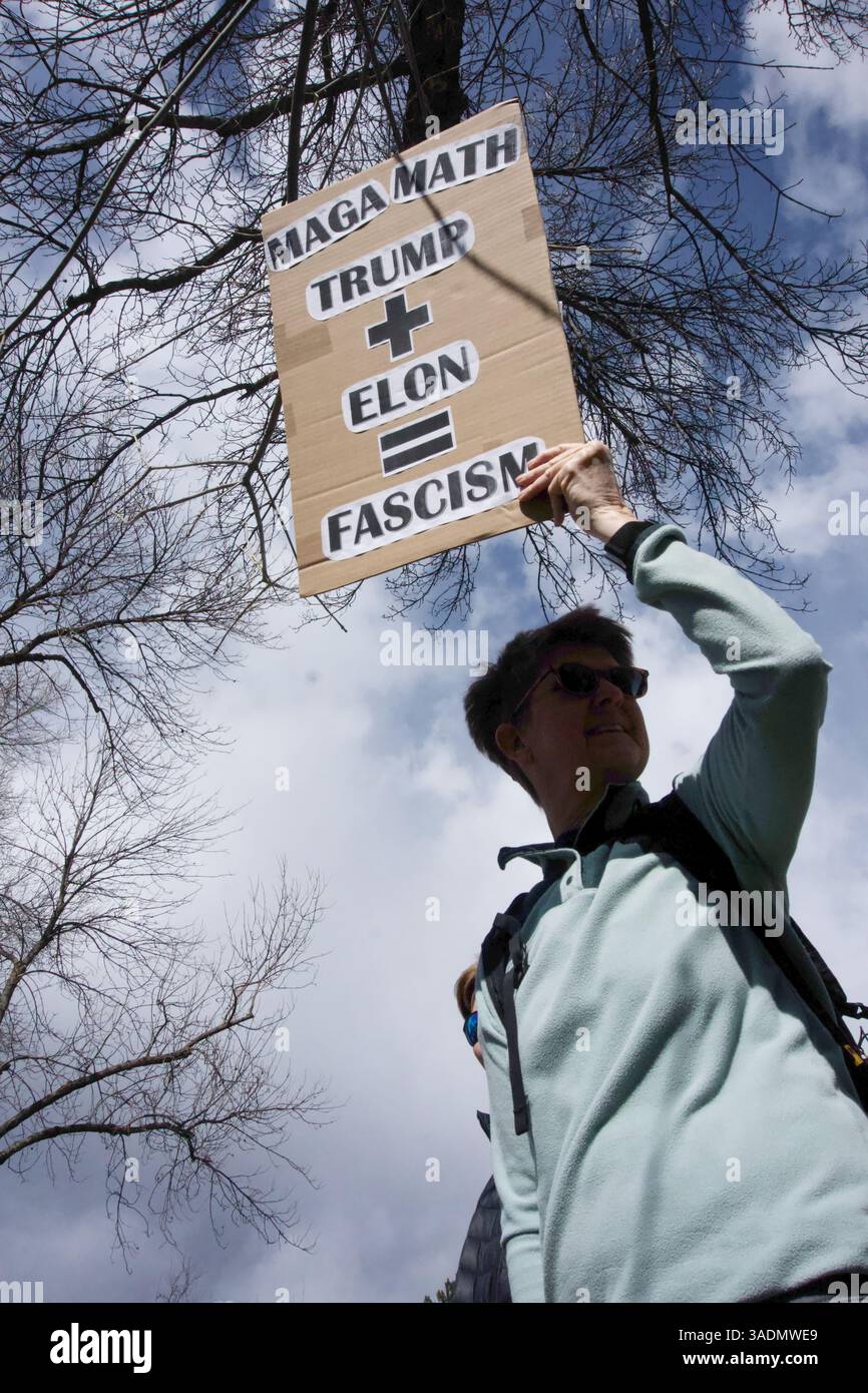 Glenwood Springs, Colorado, USA. 5 April 2025. Approximately 2000 Hands Off! Protesters gather in Sayre Park along Highway 82 to demonstrate against the policies of President Trump, Elon Musk, and DOGE. Small town, rural America shows up to defend democracy. Stock Photo