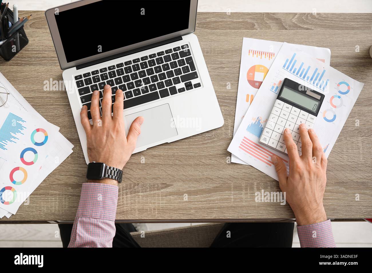 Office worker using calculator at table. Top view Stock Photo