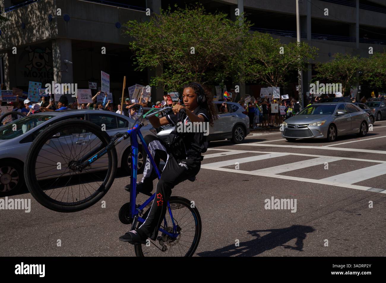 St Petersburg, Florida, USA. 5th Apr, 2025. A boy pops a wheely on his ...