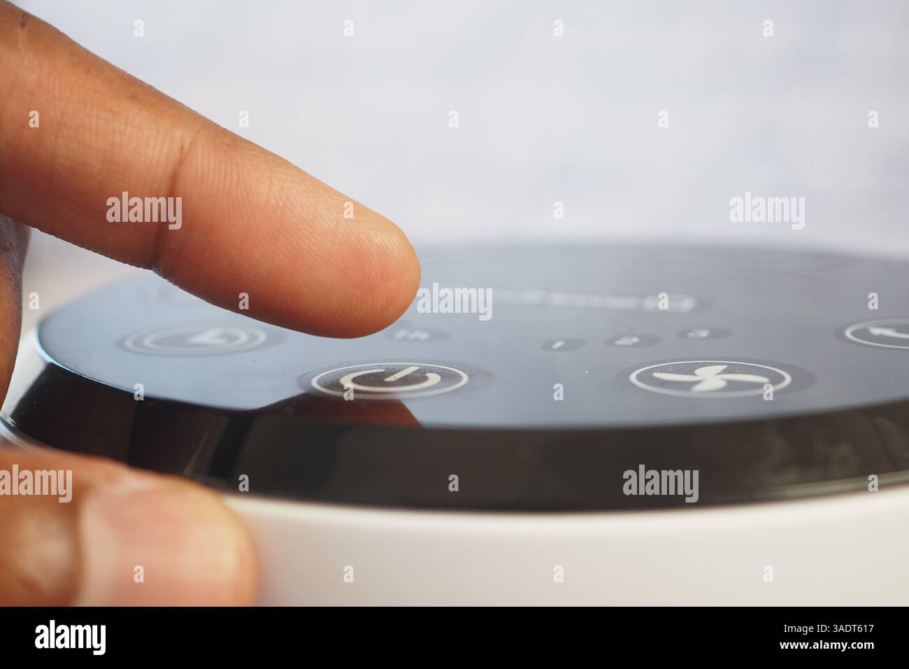 Adjusting settings on a modern device at home during the day Stock ...