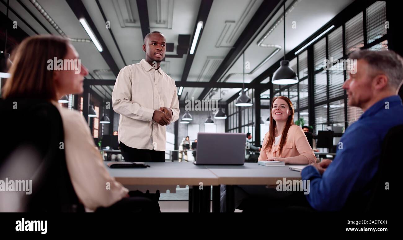 Diverse Group Of Professionals Collaborating In A Corporate Office Meeting. Stock Photo