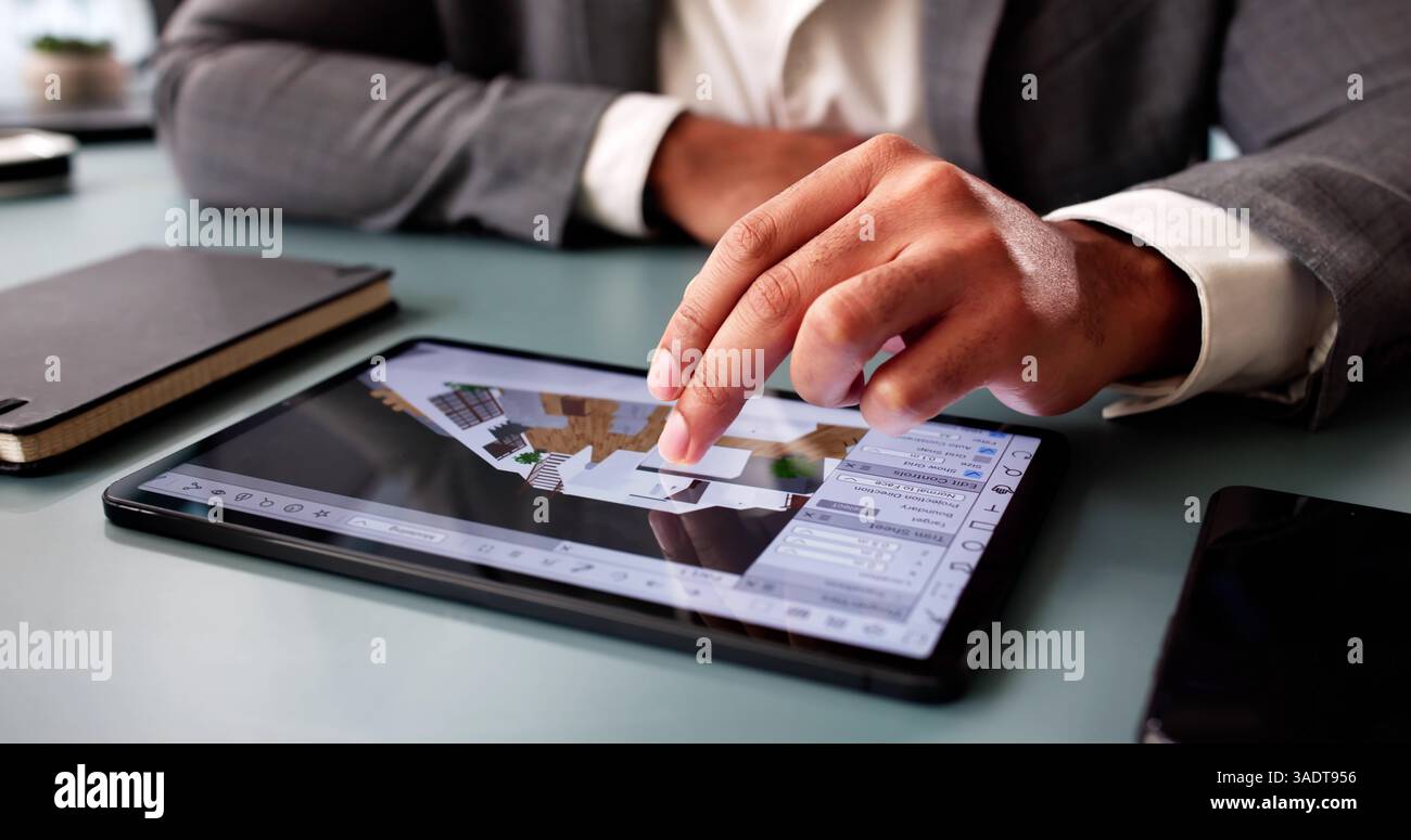 Architect Analyzing House Floor Plan for Renovation Project in CAD. Stock Photo