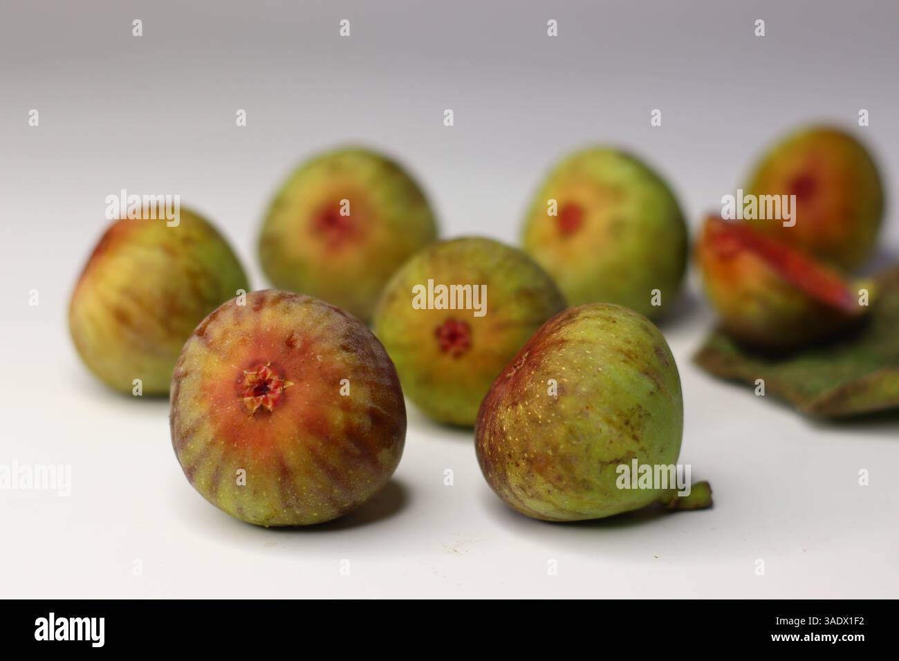 Fresh figs on a white background, showing soft texture and rich color ...