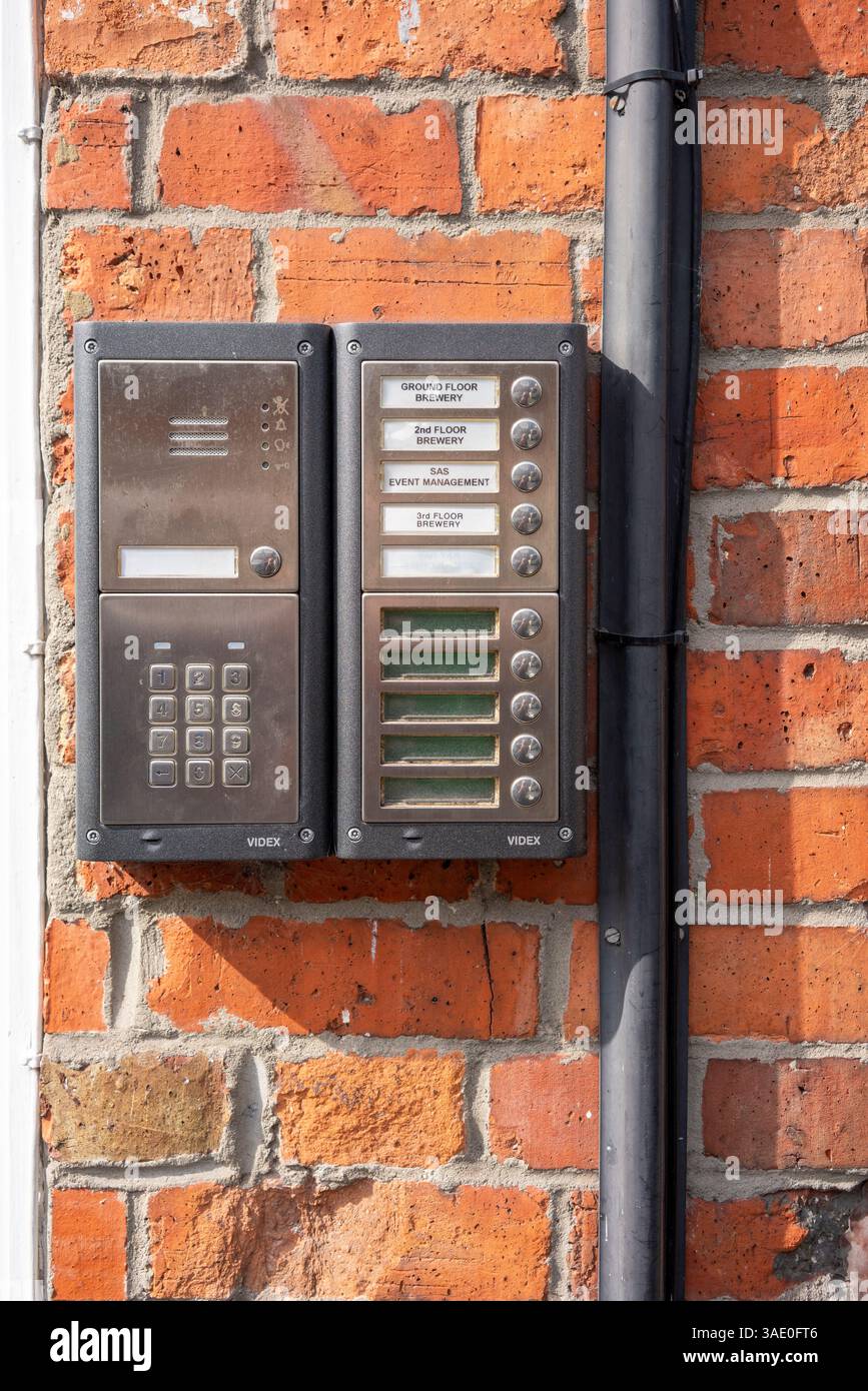 Door bell buttons and intercom on red brick wall Stock Photo