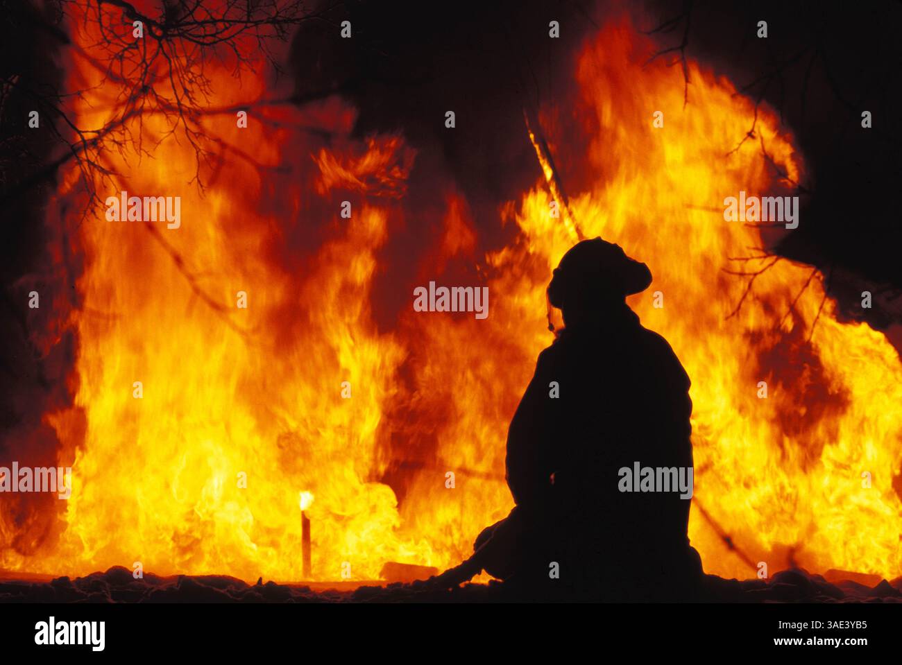 Jun 20, 1999; Coal Creek, CO, USA; A fireman looking quietly at the disasterous fire blazing and burning down everything in its way - houses, businesses, forests.   (Credit Image: Jay Quadracci/ZUMAPRESS.com) Stock Photo