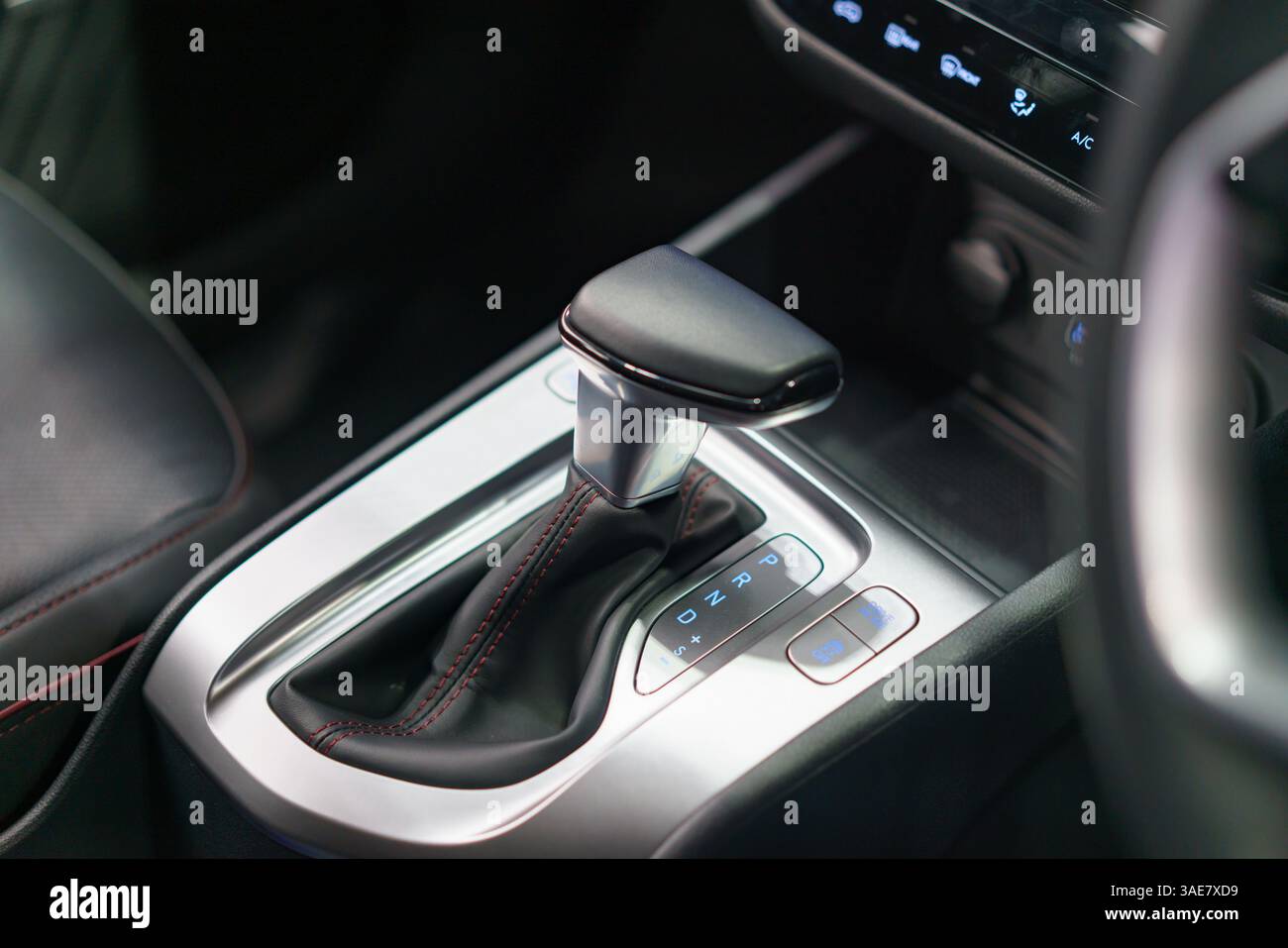 close-up of a contemporary automatic gear shift knob in a glossy car console, highlighting convenience, style, and interior automotive design. Stock Photo