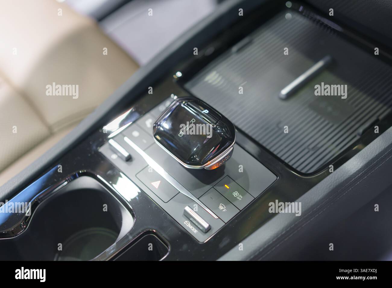 close-up of a contemporary automatic gear shift knob in a glossy car console, highlighting convenience, style, and interior automotive design. Stock Photo