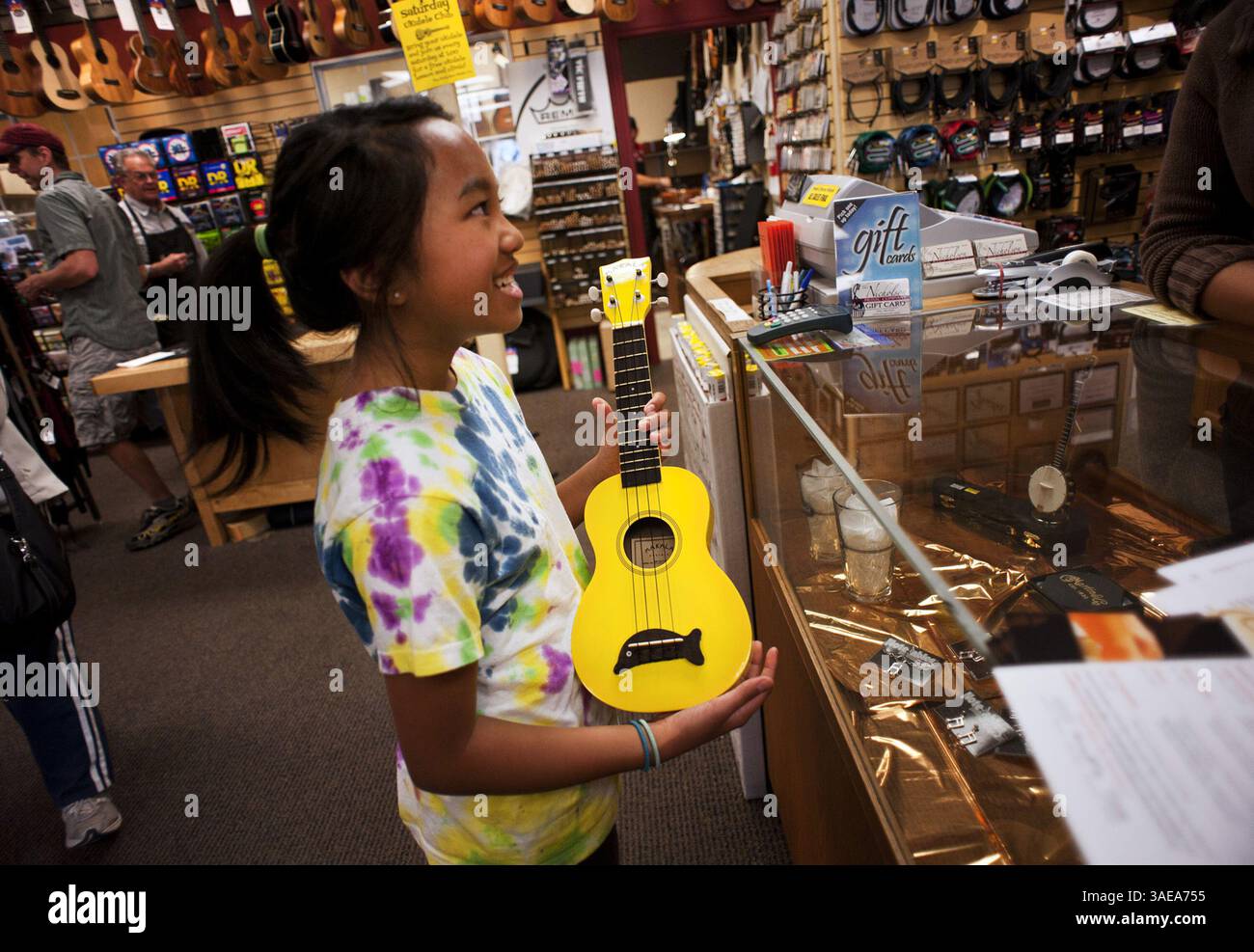 Angelina Francisco, 11, of El Dorado Hills, California, prepares to  purchase herself a new ukulele at The Nicholson Music Co. in Folsom,  California, on February 11, 2012.Francisco taught herself how to play the  instrument from YouTube videos, and she ..., image size:1300x987