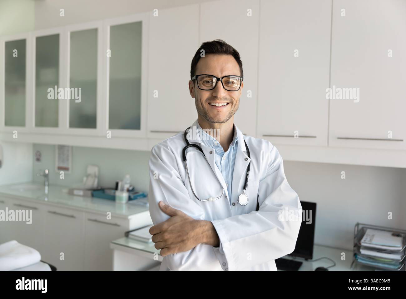 Portrait of friendly Hispanic male doctor posing in workplace Stock ...