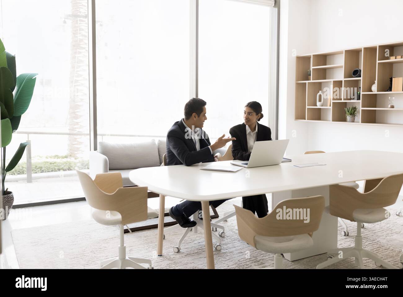 In modern conference room workmates working on common task completion Stock Photo
