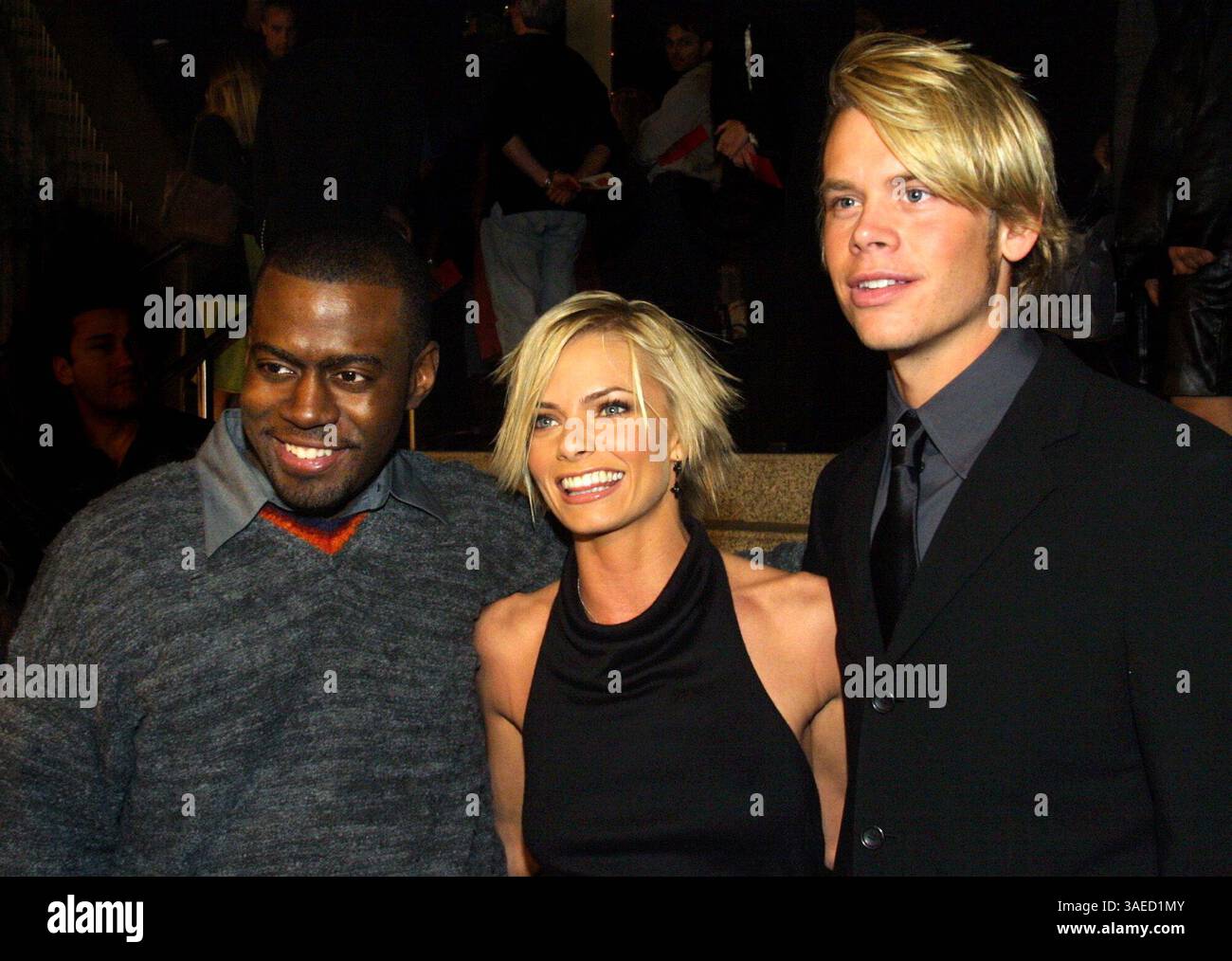 Deon Richmond posing with co-stars at a movie premiere, highlighting his charismatic presence.
