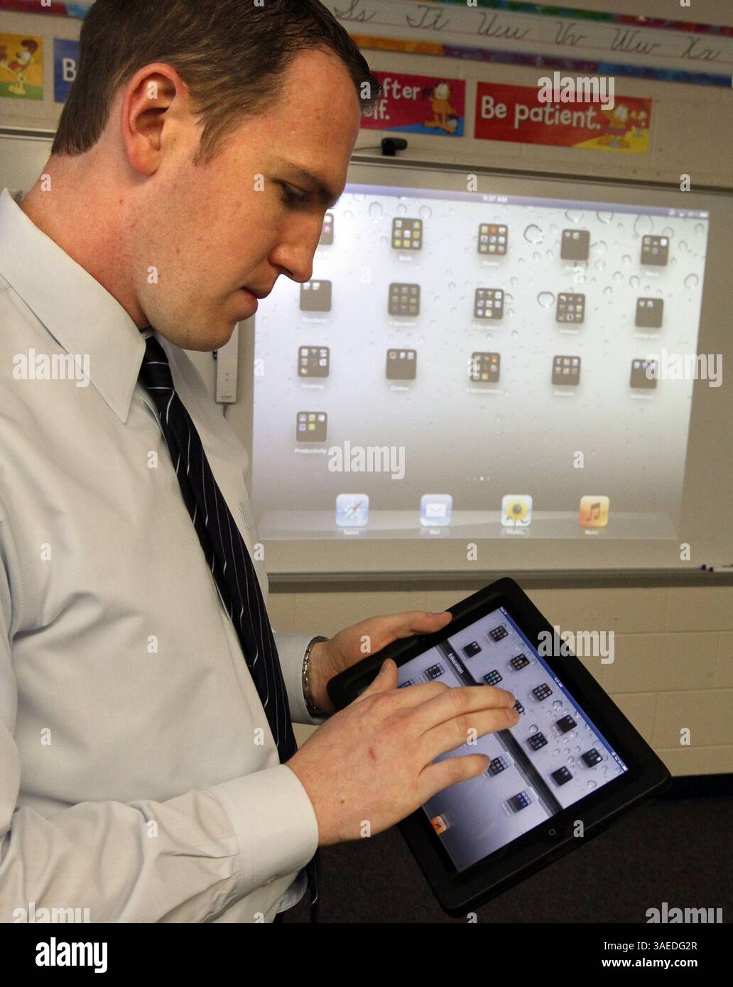 Jan. 5, 2012 - Green, OH, USA - J.T. Kuzior, third grade teacher at Green Primary School, uses an iPad that is linked to a projector to help teach Mandarin Chinese on iPads in his class in Green, Ohio, on Thursday, January 5, 2012. Local entrepreneur Randy Theken has donated the 90 iPads to the school. (Credit Image: © Paul Tople/Akron Beacon Journal/MCT/ZUMAPRESS.com) Stock Photo