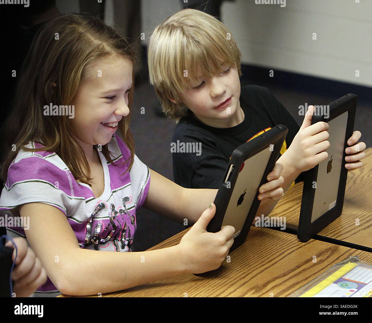 Jan. 5, 2012 - Green, OH, USA - Julianna Scheppler, 9, left, and Jamie Allen, 9, learn Mandarin Chinese using an iPad in their third grade class at Green Primary School in Green, Ohio, on Thursday, January 5, 2012. Local entrepreneur Randy Theken has donated the 90 iPads to the school. (Credit Image: © Paul Tople/Akron Beacon Journal/MCT/ZUMAPRESS.com) Stock Photo