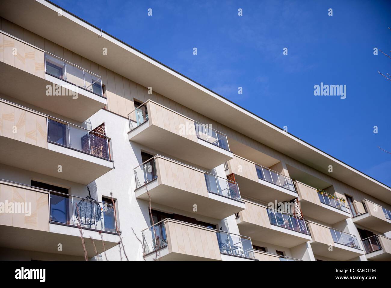 Stylish and Modern Apartment Building Featuring Balconies Beneath a ...