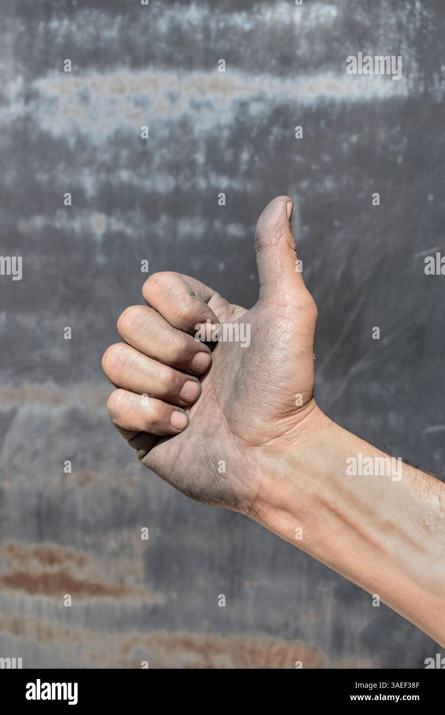 Dirty hand making a thumb. The hand of the worker. Thumbs up Stock Photo