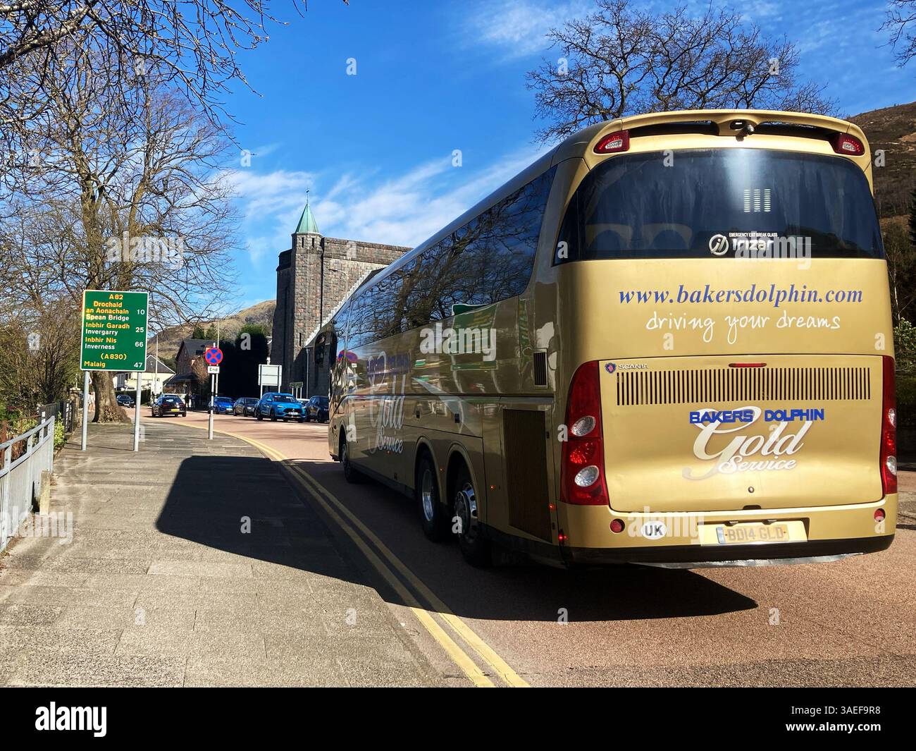 Bakers Dolphin coach tour bus heading north on the A82 through Fort William, Scotland - Smartphone Captured Stock Image