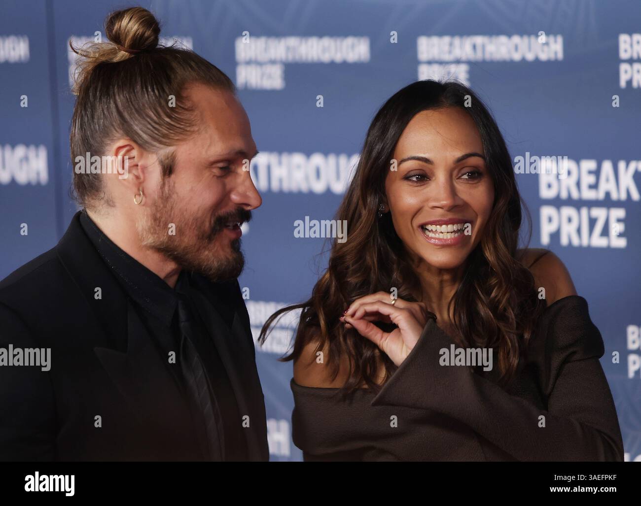 Santa Monica, USA. 06th Apr, 2025. Marco Perego, Zoe Saldaña attend the ...