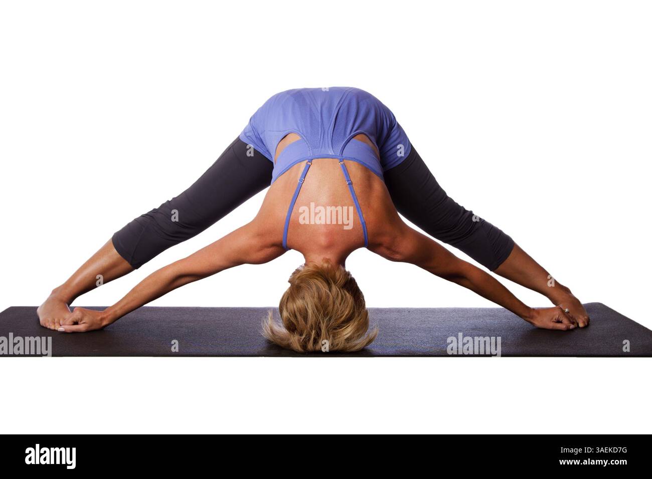 Beautiful healthy woman doing inversion Standing Intense Spread Leg