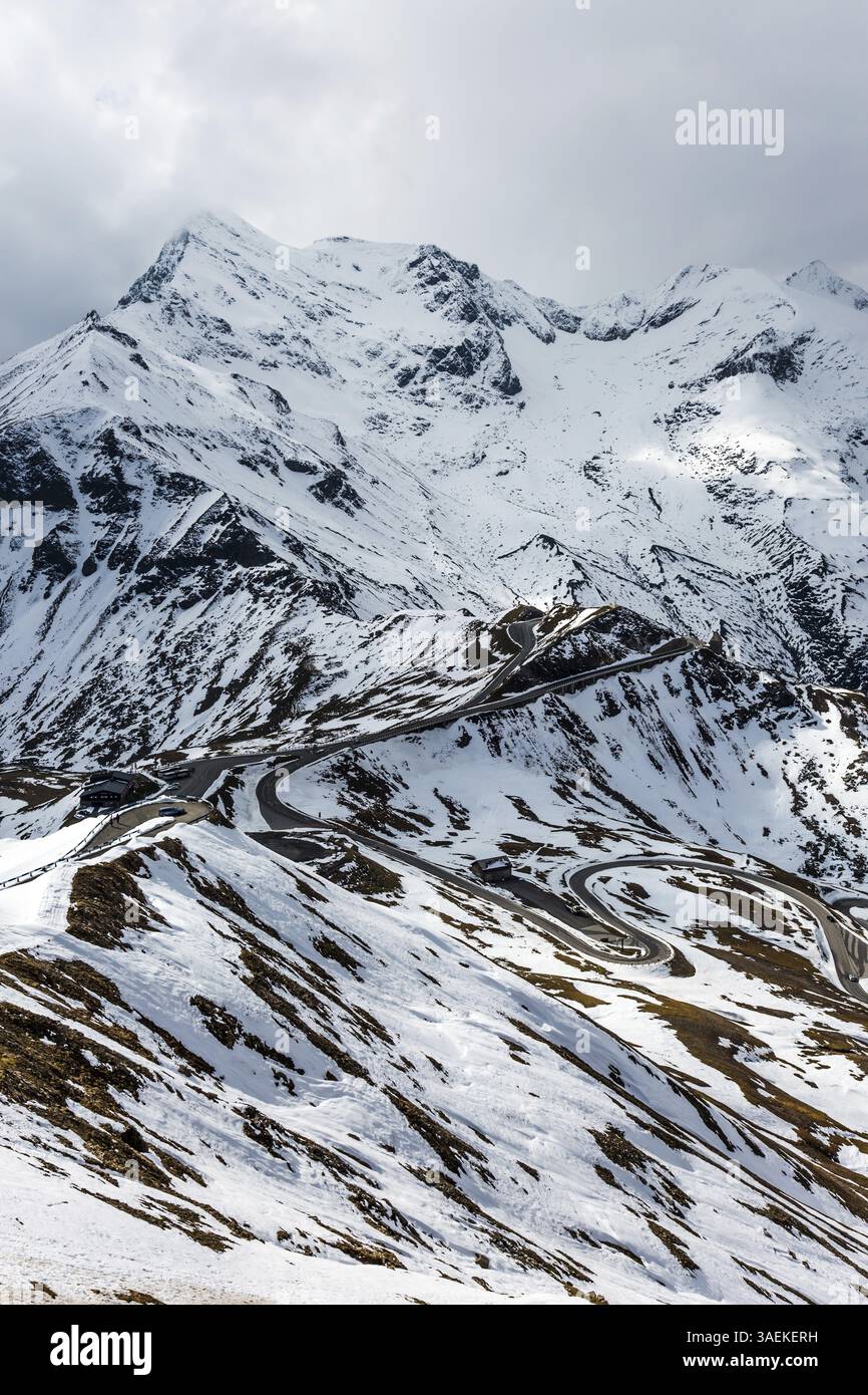 Grand Austrian Alps. The snow on the mountainside began to melt. Dizzy turns of mountain serpentine of Grossglocknerstrasse The concept of active, eco Stock Photo