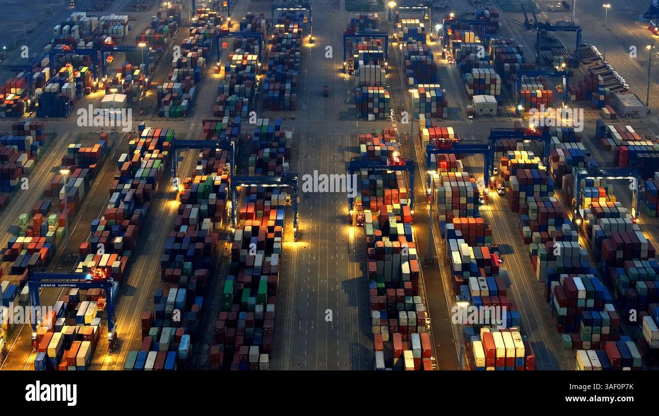 Cargo ships load and unload containers in an orderly manner at the ...