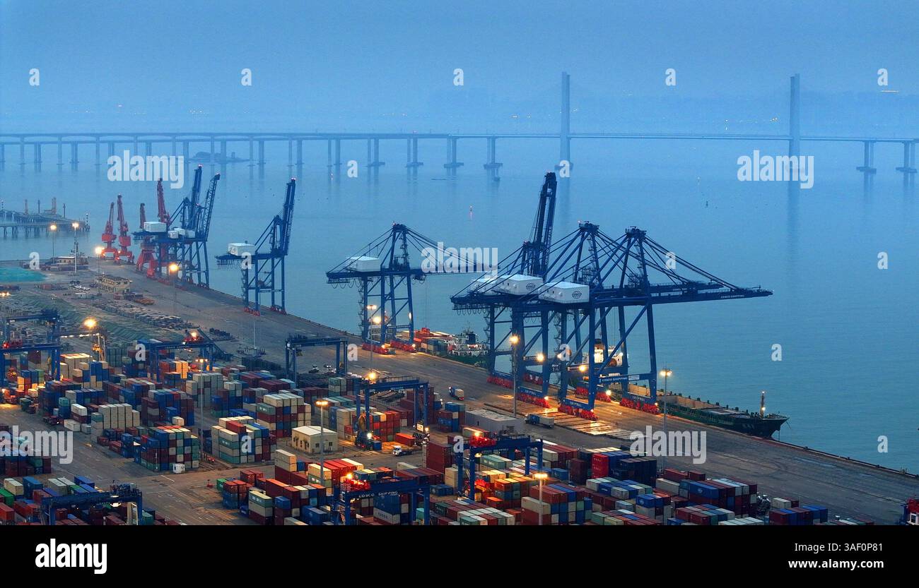Cargo ships load and unload containers in an orderly manner at the ...