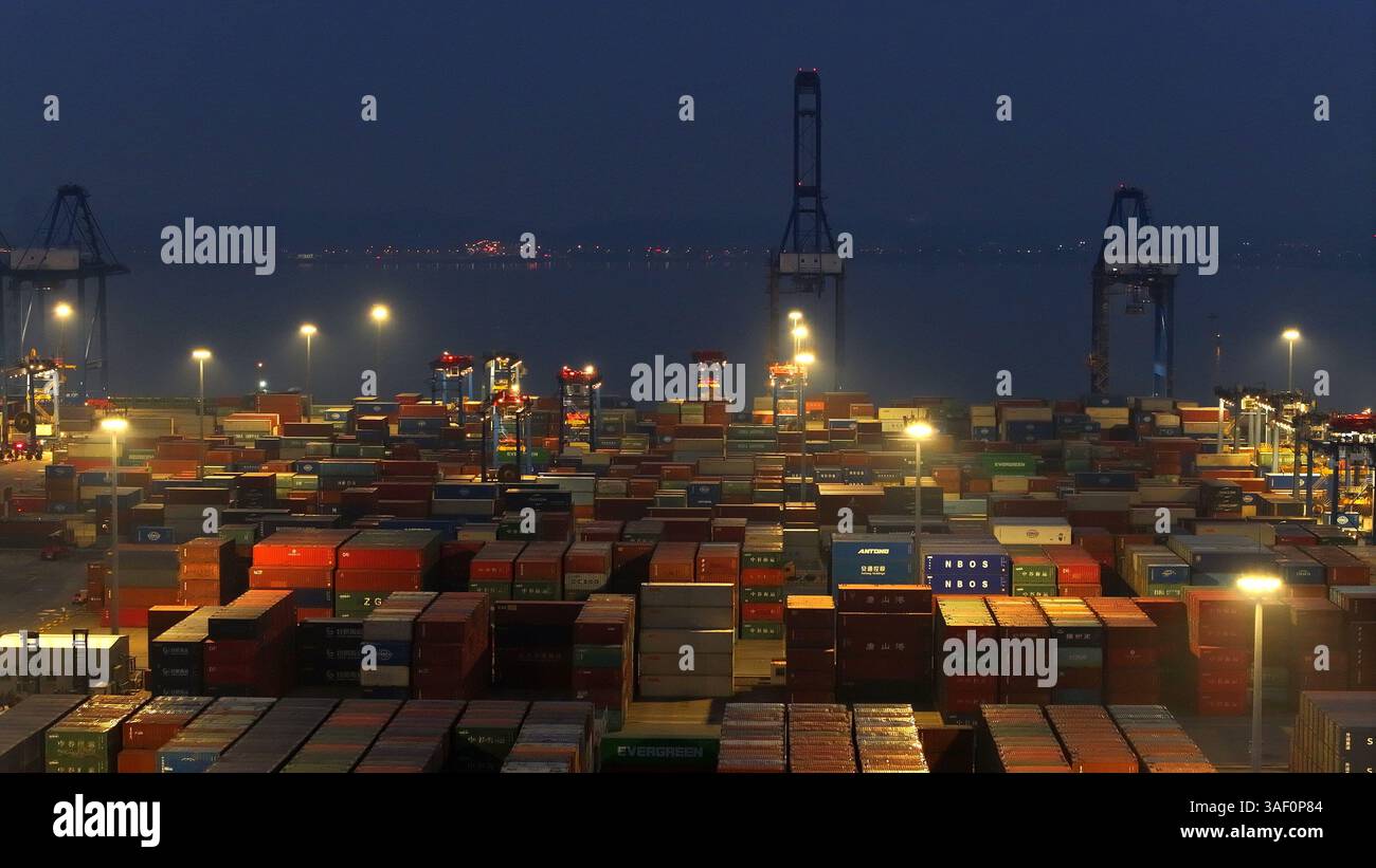 Cargo ships load and unload containers in an orderly manner at the ...