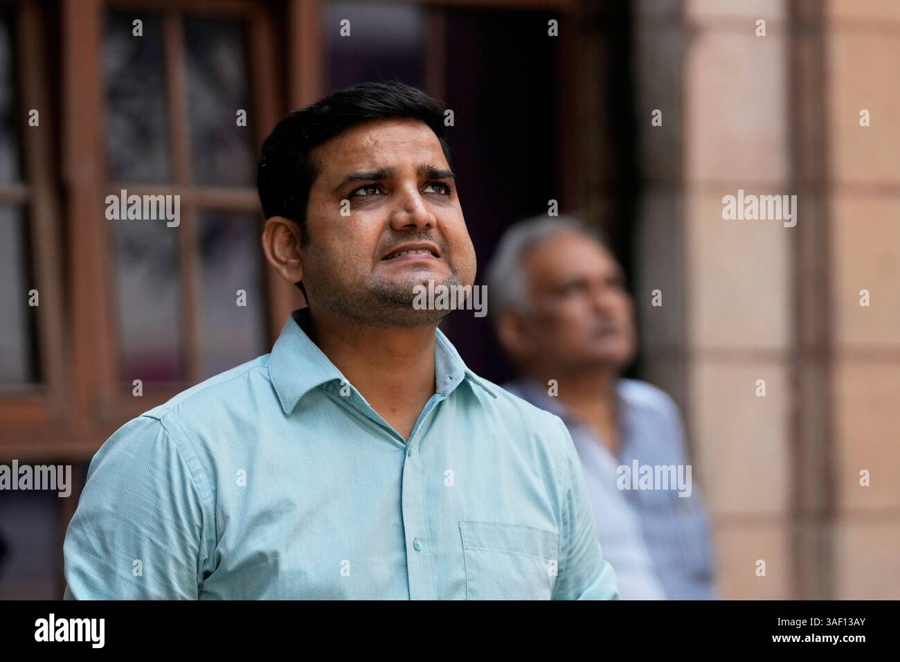 A man watches a live screen on the facade of Bombay Stock Exchange (BSE ...