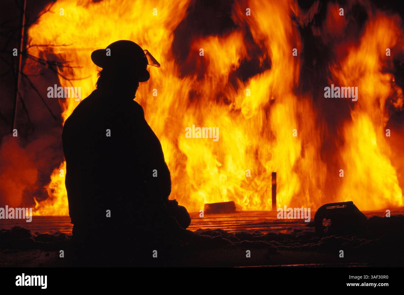 Jun 20, 1999; Coal Creek, CO, USA; A fireman looking quietly at the disasterous fire blazing and burning down everything in its way - houses, businesses, forests.  (Credit Image: © Jay Quadracci/ZUMAPRESS.com) Stock Photo