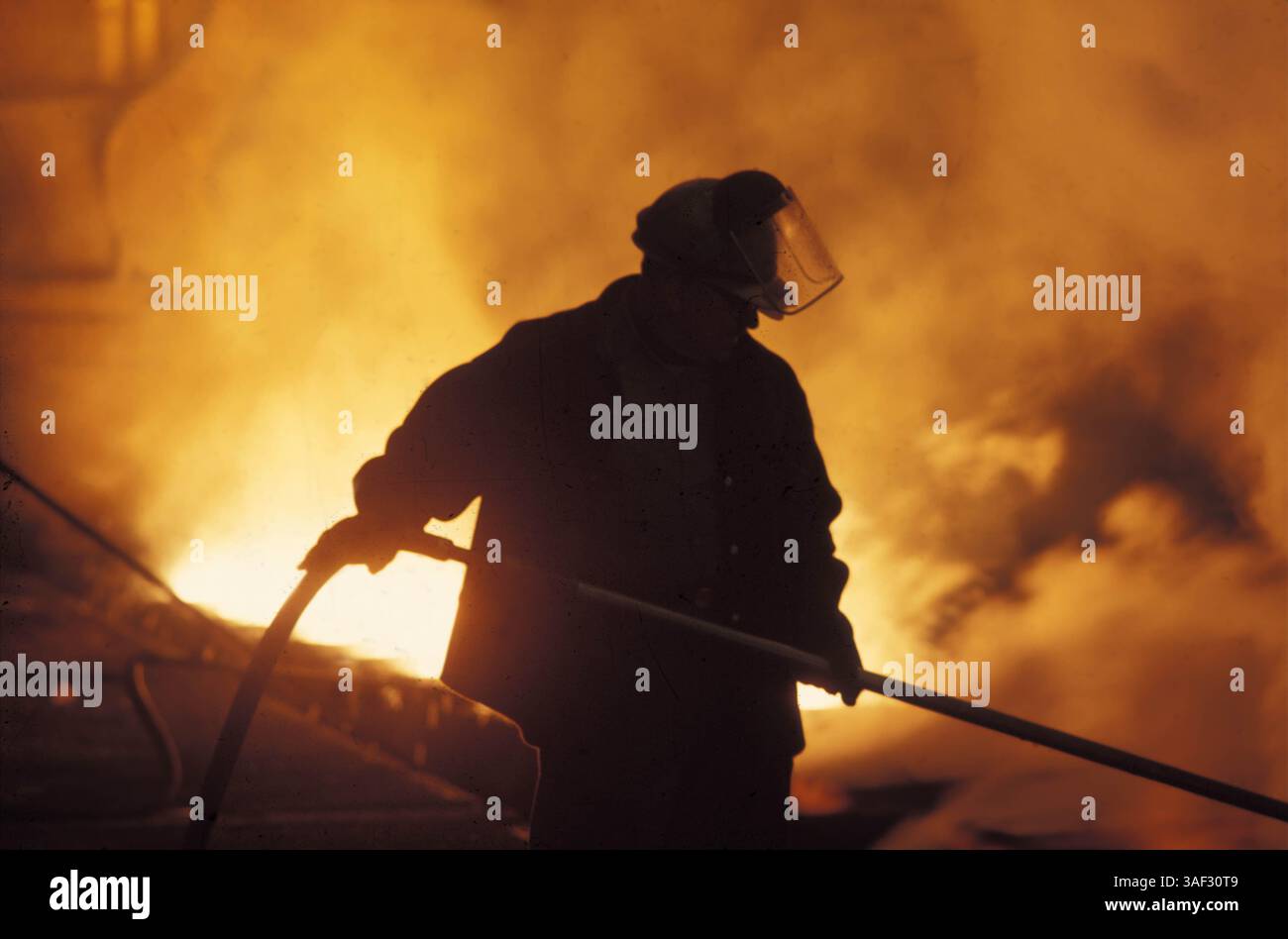 Jun 22, 1998; Port St. Lucille, FL, USA; A fireman putting out the disasterous wildfire blazing and burning down everything in its way - houses, businesses, forests. Stock Photo