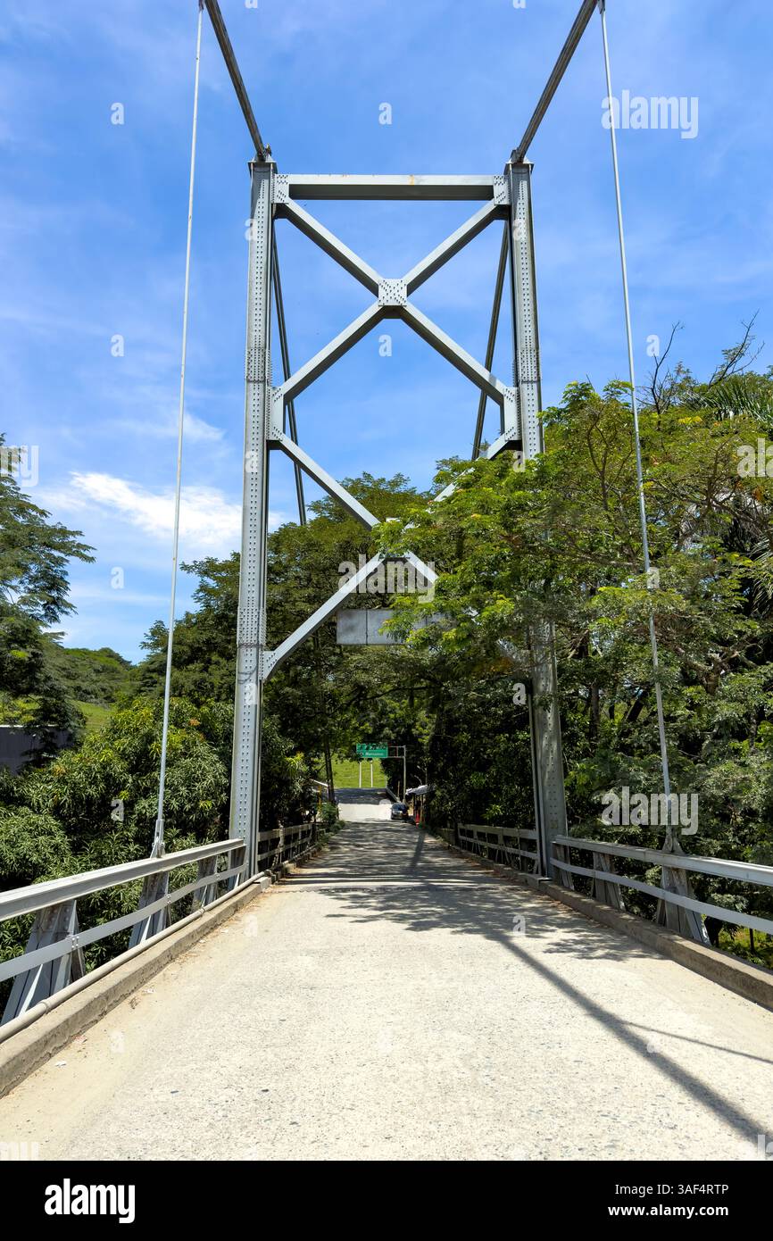 The steel suspension bridge over the Cauca River at Mirador de Cauca, La Pintada in Colombia. Stock Photo