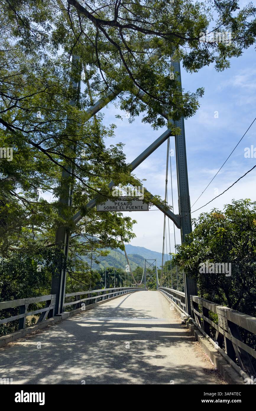 The steel suspension bridge over the Cauca River at Mirador de Cauca, La Pintada in Colombia. Stock Photo