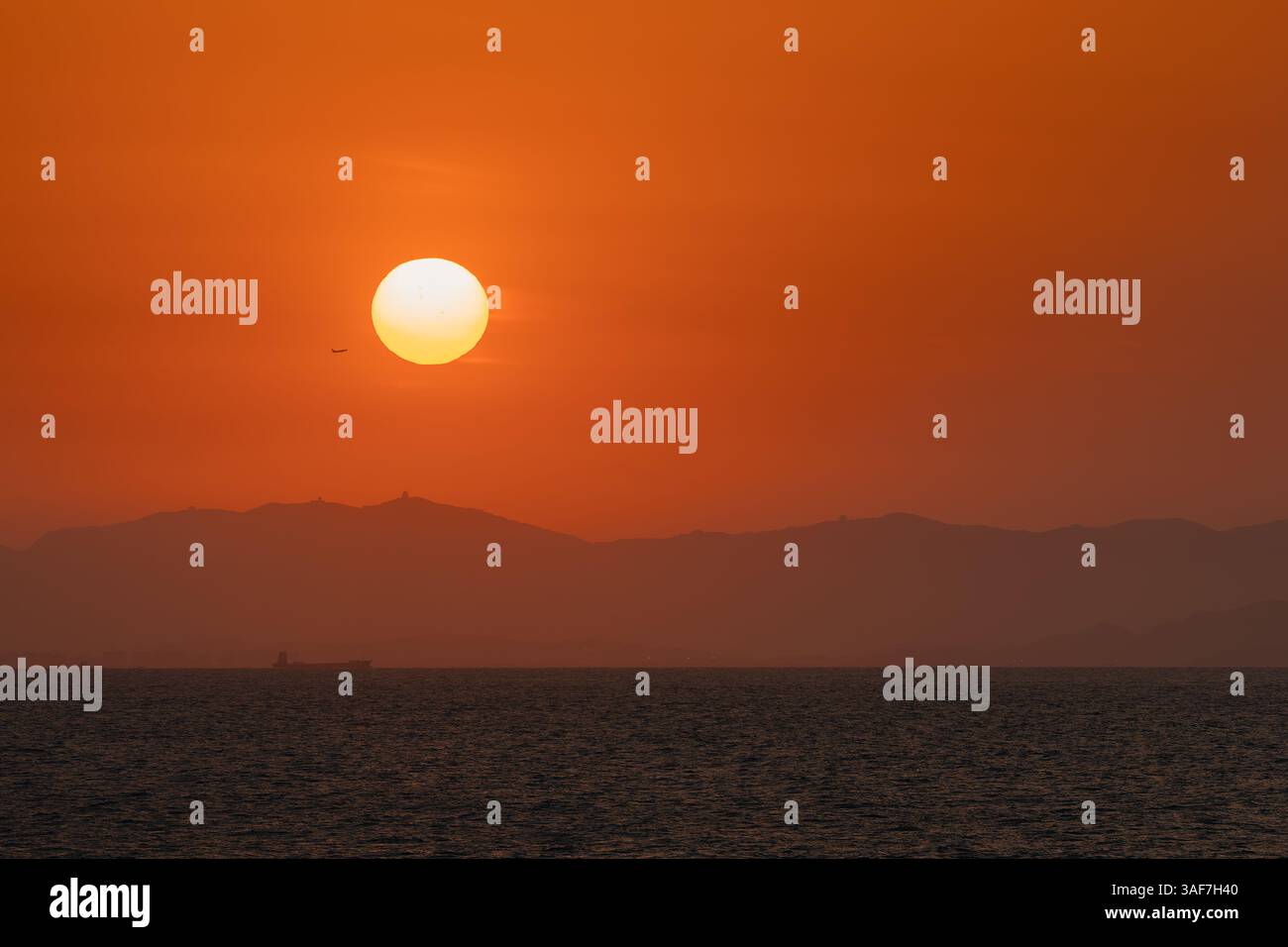 Plane taking flight in the sunset over China Stock Photo