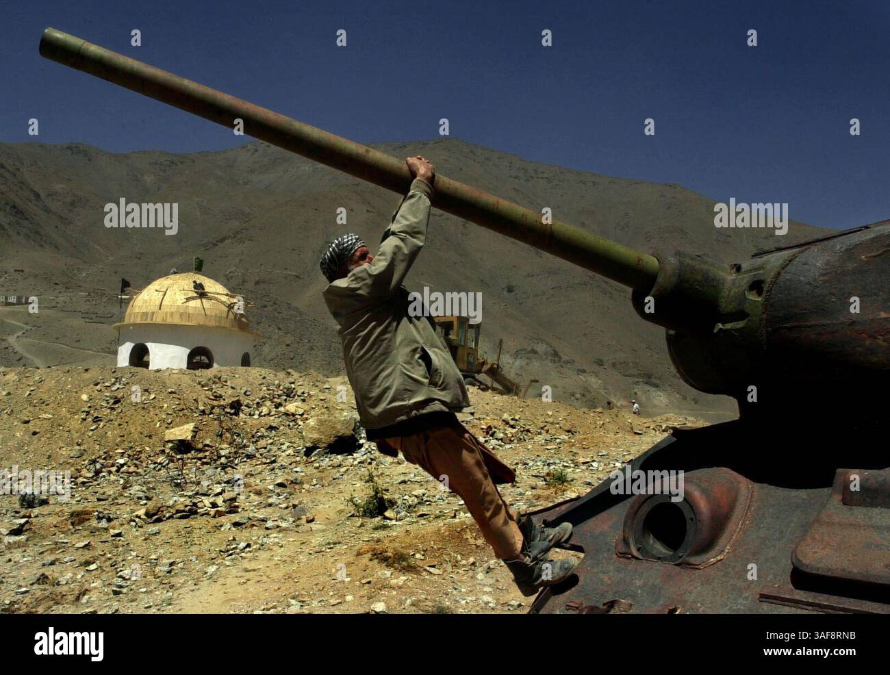 OT.144538.- - DELIVER TO:.News.- -.8/25/2002..Afghanistan.A worker at ...