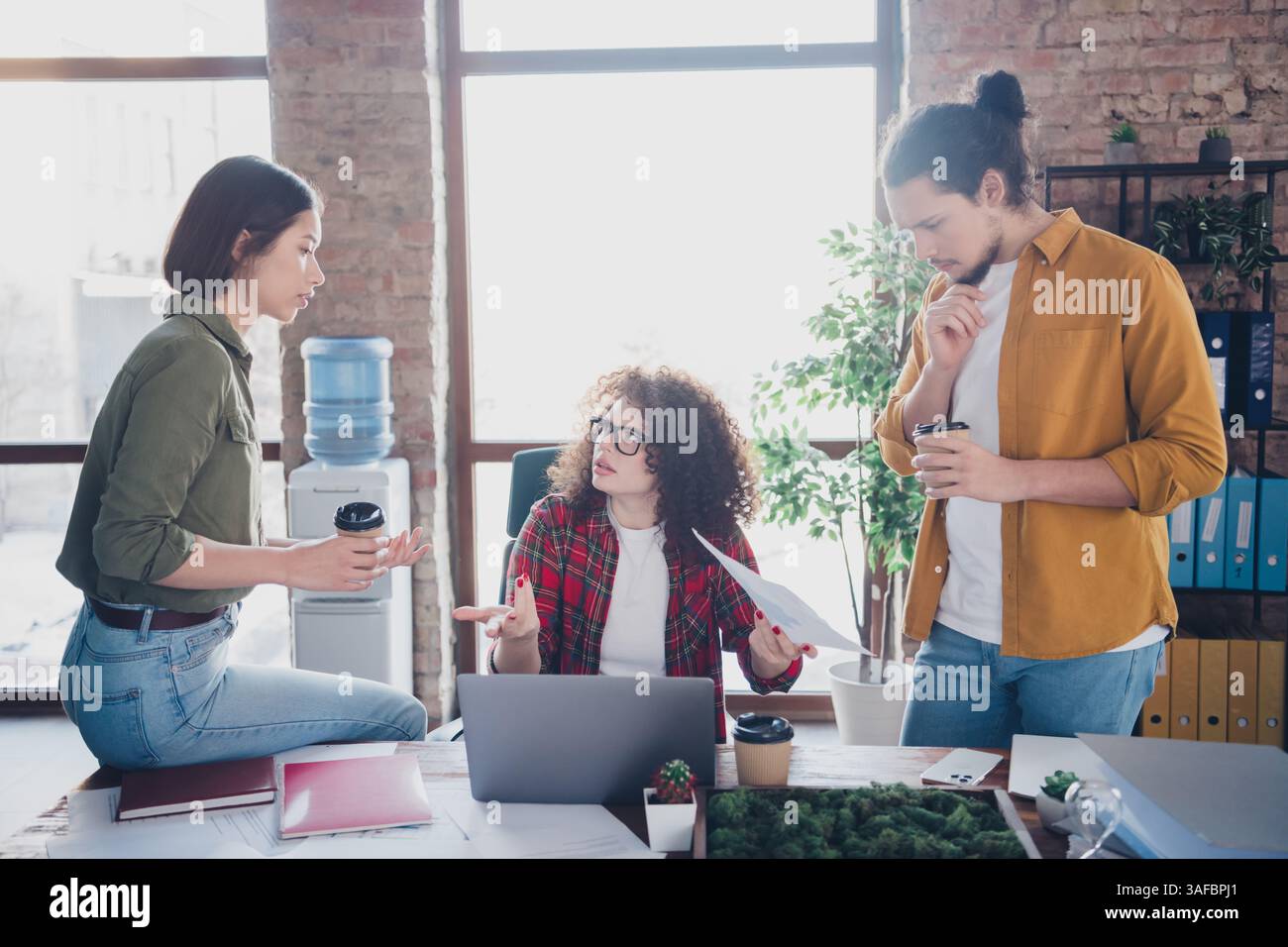 Young professionals collaborating in a modern office environment ...