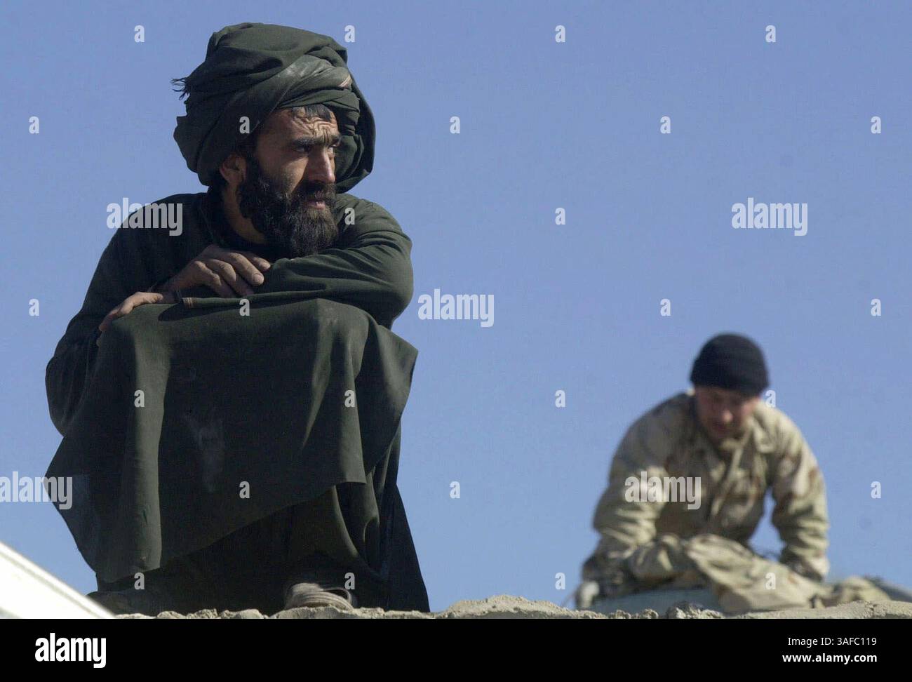 Po First Class Dec 20, 2001; Kandahar, AFGHANISTAN; An Afghan foreman watches fellow ...