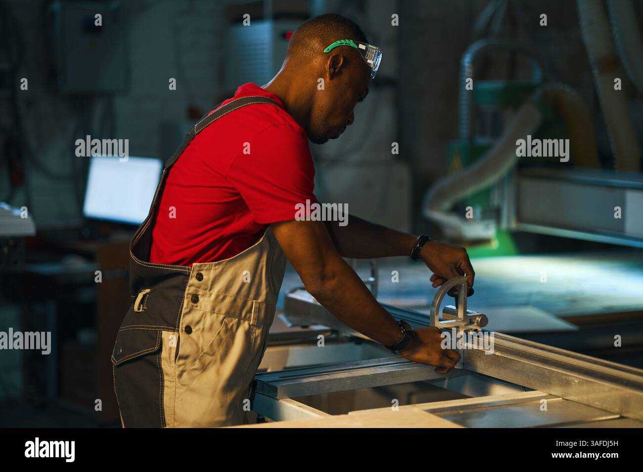 Workman Working On Lathe In Factory Stock Photo
