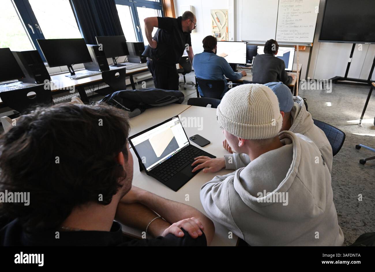 Stuttgart, Germany. 07th Apr, 2025. Trainees work on computers in a ...