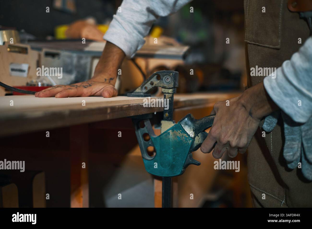 Female Worker Working With Tool In Workshop Stock Photo