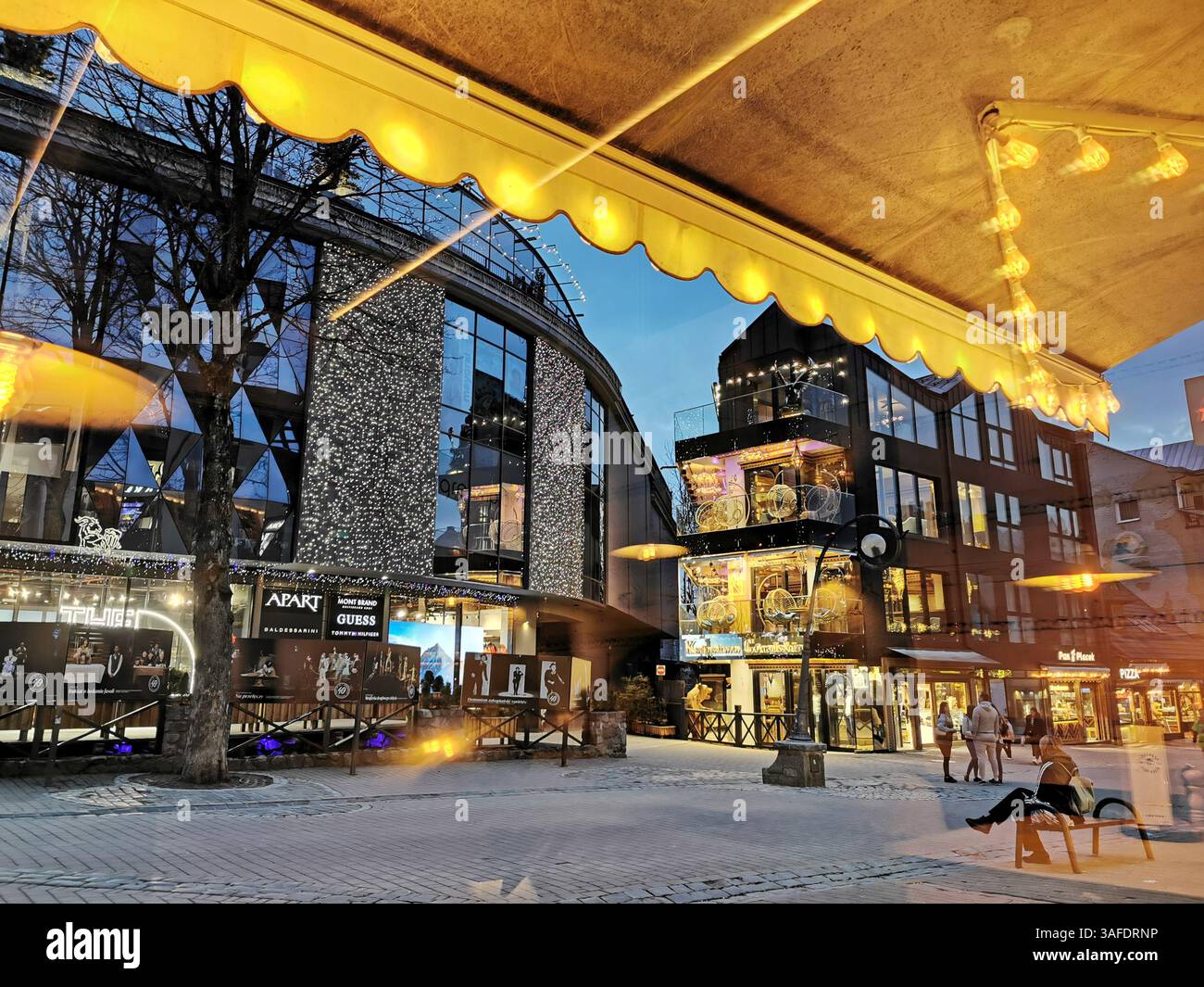 Night scenes on Krupowki main street in Zakopane Poland. Shopping centres and lively bars. This photo is the view from Karczma Biały Miś. - Smartphone Captured Stock Image