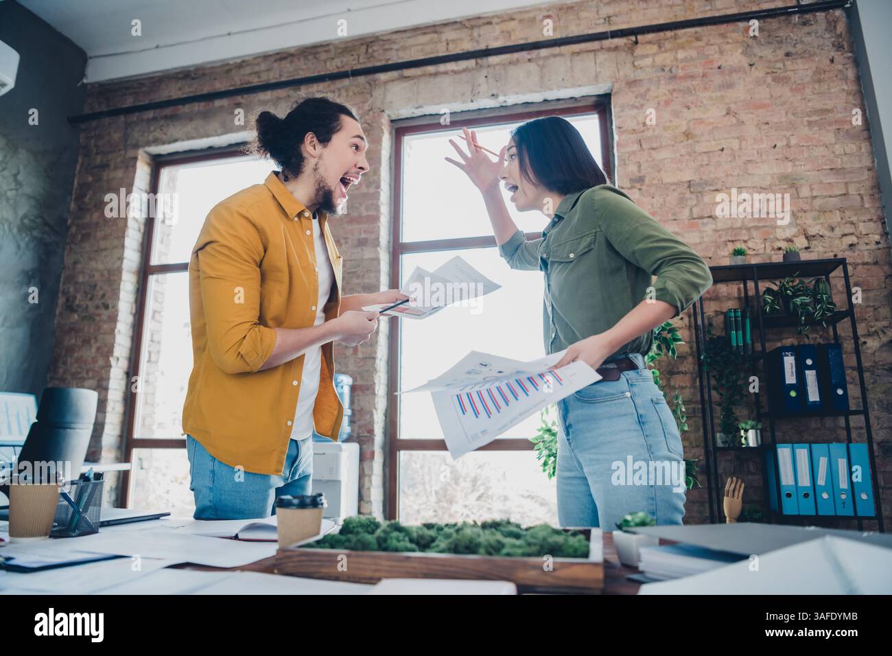 Colleagues Celebrating Successful Project Completion with Enthusiasm in a Bright Modern Office Stock Photo