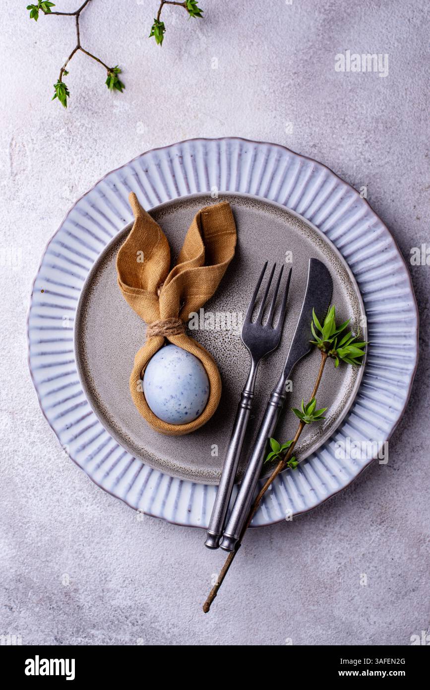 Elegant Easter table setting with painted egg Stock Photo