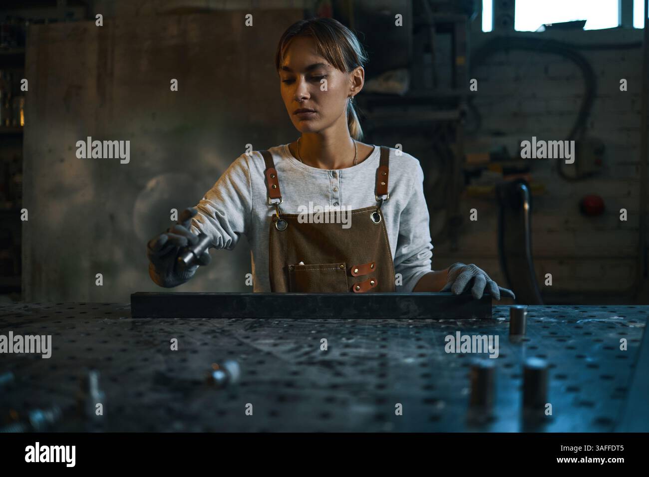 Worker Making Metal Details In Workshop Stock Photo