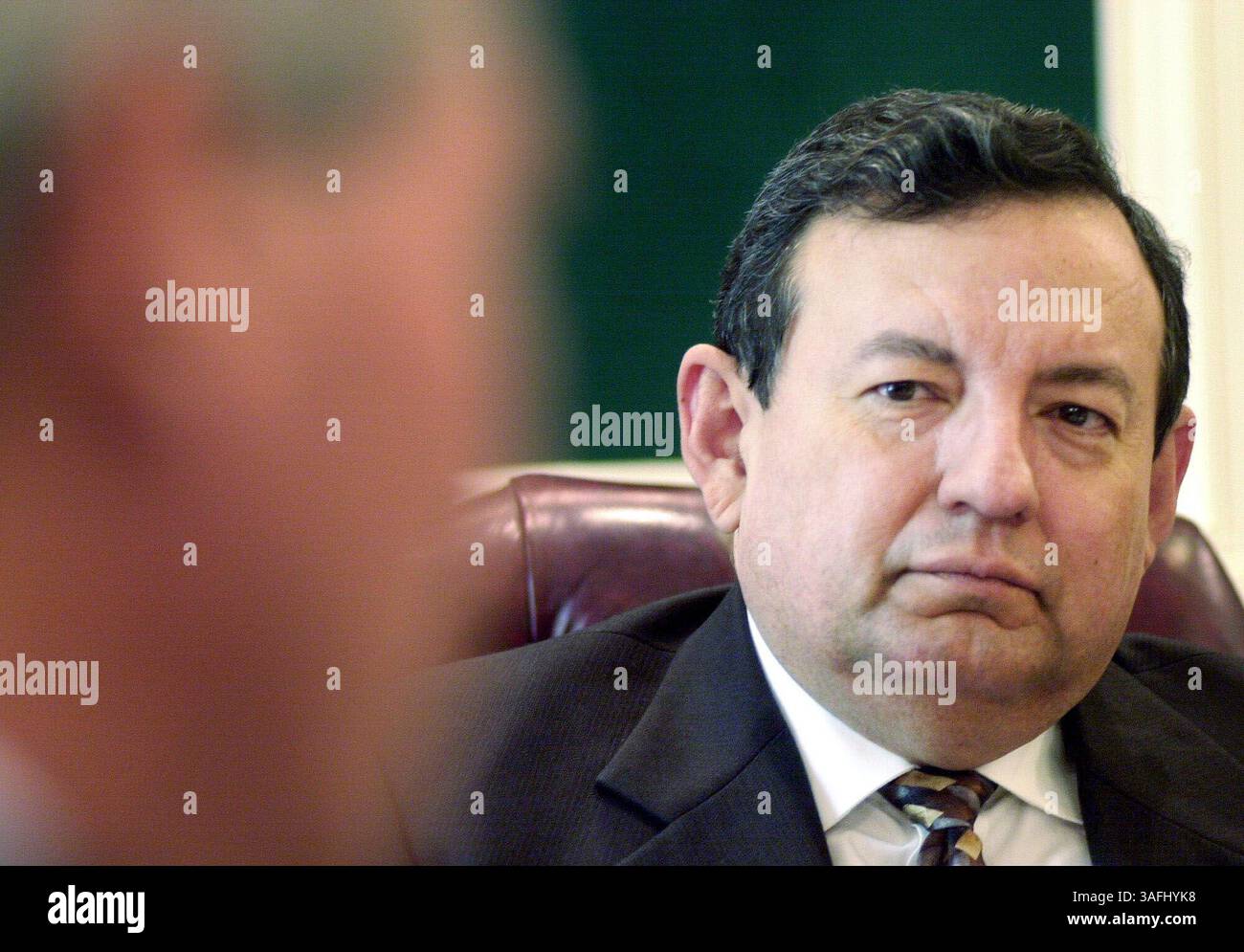 H.E. Guillermo Perez-Cadalso Arias, Minister for Foreign Relations, listens to President of Honduras, Ricardo Maduro Joest, who talks to reporters of the Washington Times at TWT office building in NE Washington DC, April 28, 2003. PLEASE CHECK ID FOR I USE NAMES FROM SEATING ORDER GIVEN TO ME. (Credit Image: The Washington Times/ZUMAPRESS.com) Stock Photo