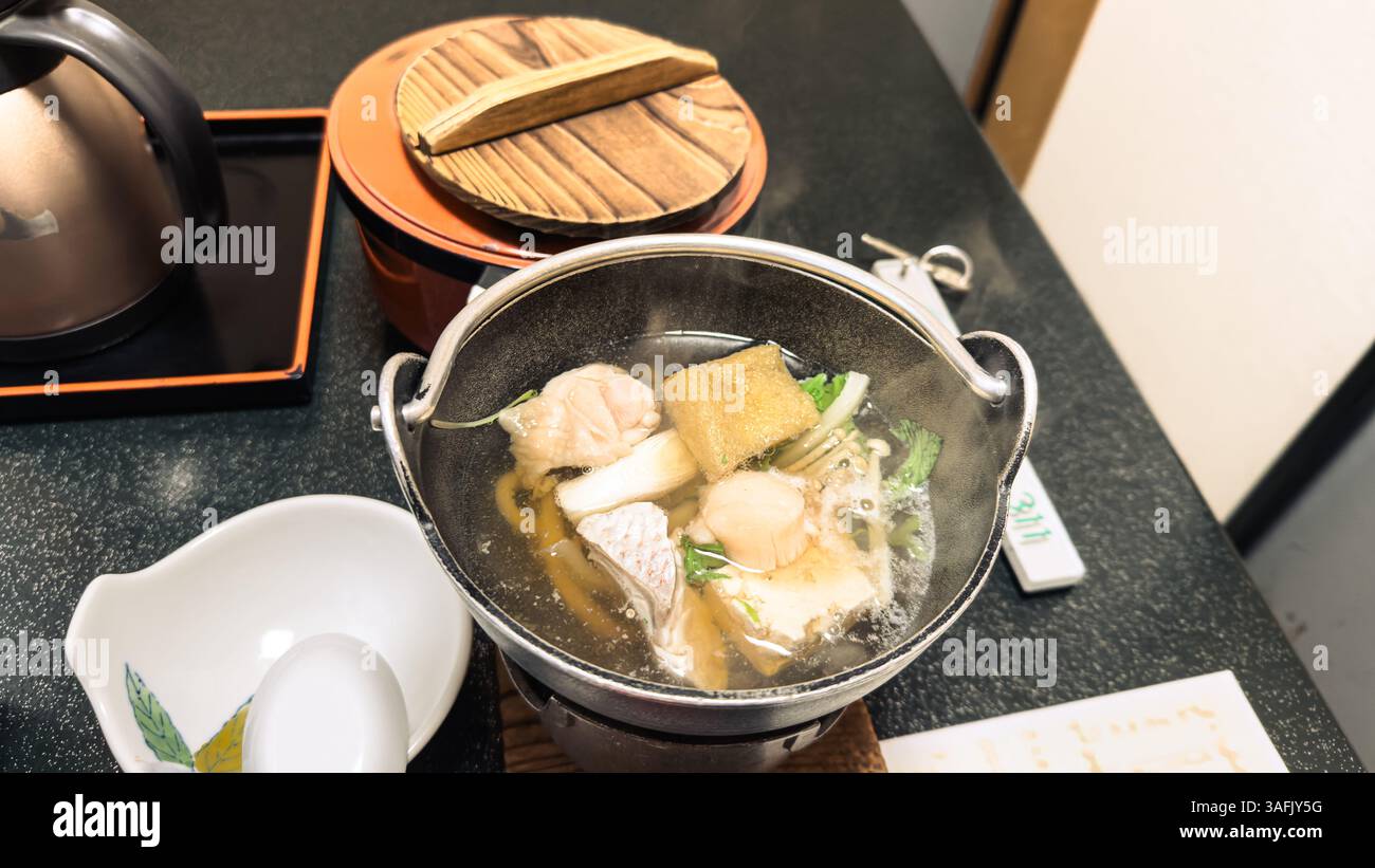 Traditional Kaiseki tasting meal and dinner experience in luxury Japanese ryokan with seasonal dishes - Smartphone Captured Stock Image