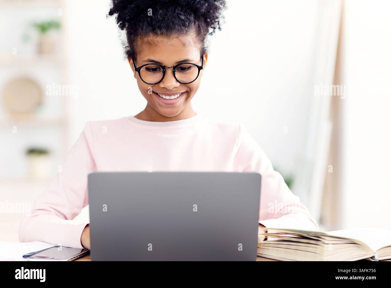 Happy African Teen Girl Studying At Laptop Computer At Home Stock Photo ...