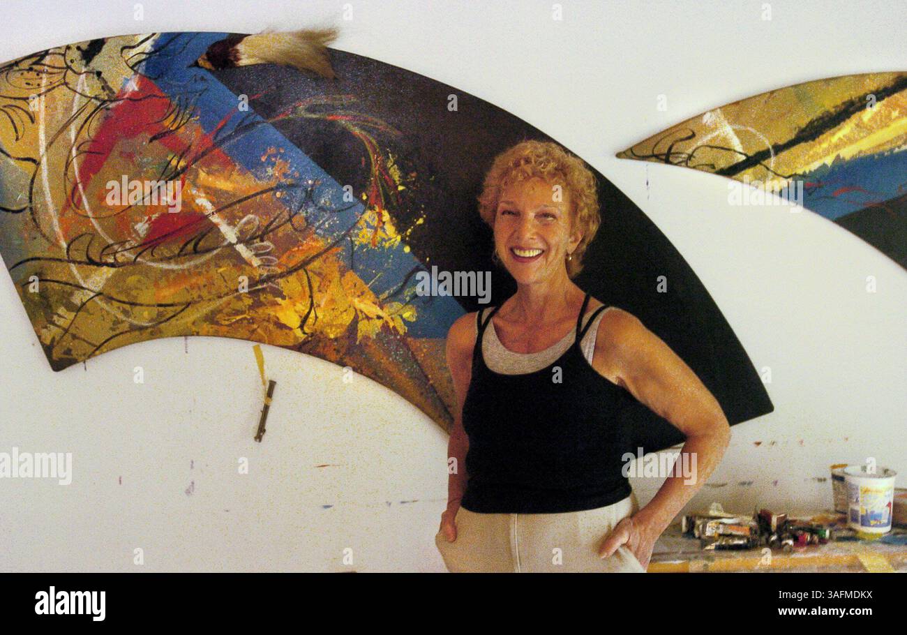 Arline is standing in her garage where she and her assistant Kathy Merrigan, cq, were packing paintings that would be in the show. Behind her is a two part panel called the Dragon and the Pure One meet the Phoenix of Cinnabar Mountain, cq, painted in 1989. more info www.arlineedrich.com. Aripeka artist Arline Erdrich, cq, is preparing for a 30-year retrospective exhibit of her work at the Gulf Coast Museum of Art in Largo. The exhibit opens May 7 and runs for about a month. Barbara Fredricksen will write a column about Erdrich and her exhibit that will run May 1. We want to shoot photos of Erd Stock Photo