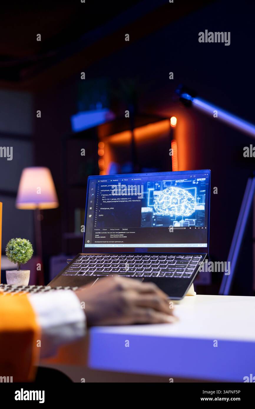 AI expert writes code on laptop in apartment office using Java programming languages. Artificial intelligence programmer remotely working on fixing database errors while working from home, close up Stock Photo